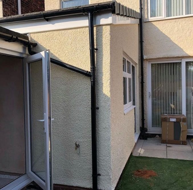 Newly built rendered rear extension with French doors