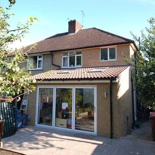 Completed single-storey rear extension with sliding doors on a semi-detached house