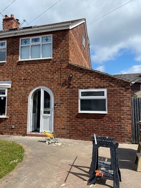 Front of the house after the garage was converted, with a new window in place of the garage door