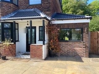 The same frontage after the garage conversion, with a new window and extended porch canopy