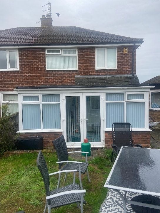 The rear of the property with the dated conservatory