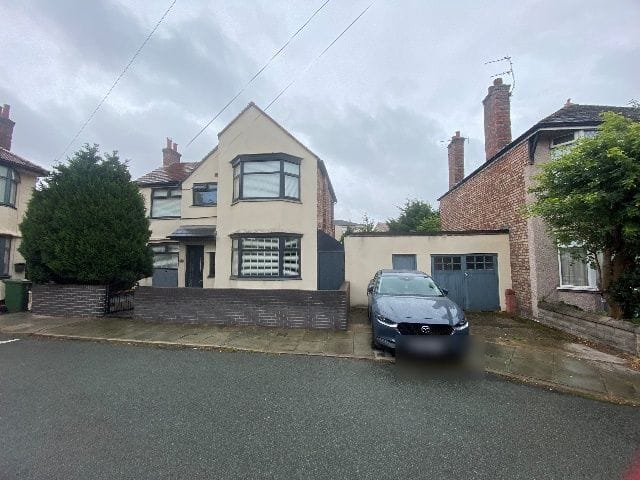 The front of the property before the works, with the original side garage and shed