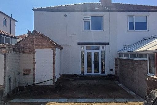 The rear of the house before the works, with an old outside toilet and brick shed