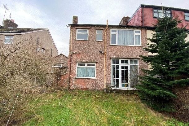 Rear and side of a pebble-dashed semi-detached house before the side extension