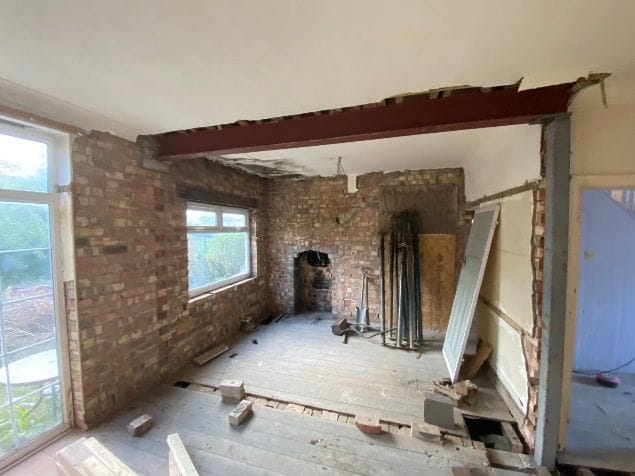 The first structural steel beam installed with its supporting post