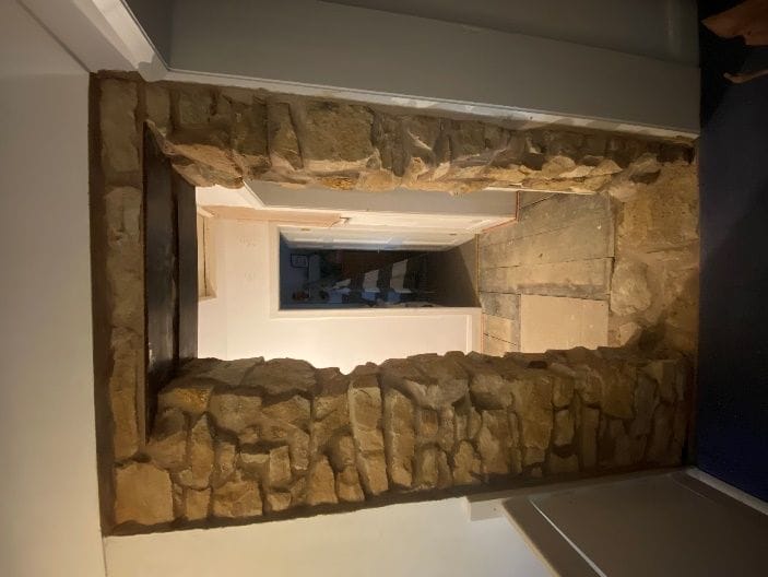 The new circulation opening formed through the original sandstone wall